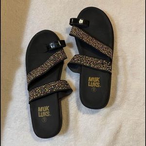 Black strapped Muk Luk sandals
